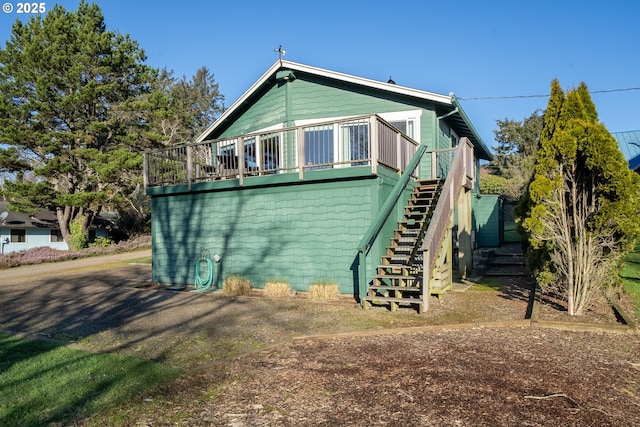 back of property with a wooden deck