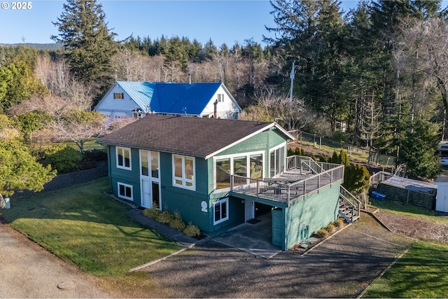 view of front of home featuring a deck and a front lawn