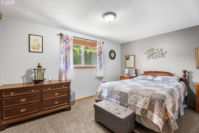 bedroom featuring light colored carpet and a textured ceiling