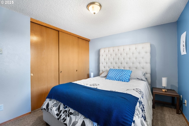 bedroom with a closet, a textured ceiling, and carpet