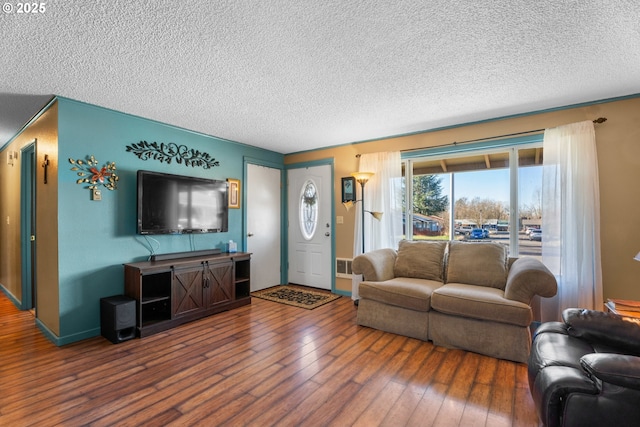 living room with hardwood / wood-style flooring and a textured ceiling