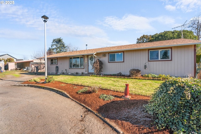 ranch-style home with a front lawn and a carport