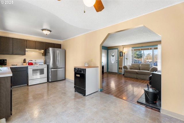 kitchen with dark brown cabinetry, a textured ceiling, electric range, stainless steel fridge, and ceiling fan