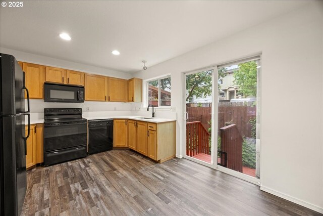 8527 N Princeton St, Portland, OR 97203 - kitchen with black appliances, dark wood-type flooring, light countertops, and recessed lighting