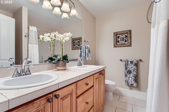 bathroom featuring tile patterned flooring, a sink, a chandelier, and toilet