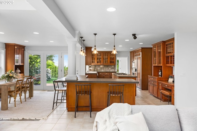 6322 Pony Ct, West Linn, OR 97068 - kitchen with a peninsula, recessed lighting, light tile patterned floors, glass insert cabinets, and a breakfast bar area
