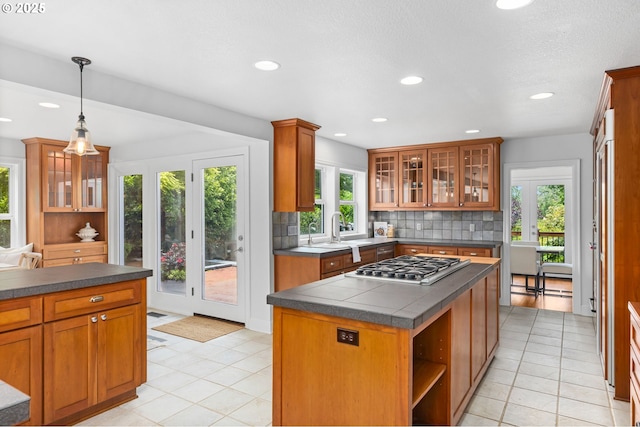 6322 Pony Ct, West Linn, OR 97068 - kitchen with stainless steel gas stovetop, backsplash, brown cabinets, recessed lighting, and open shelves