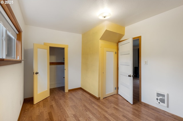 939 Buckhorn Rd, Roseburg, OR 97470 - unfurnished bedroom with a closet, baseboards, light wood finished floors, and heating unit