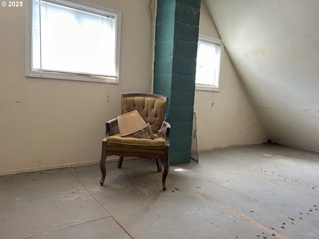 sitting room with lofted ceiling