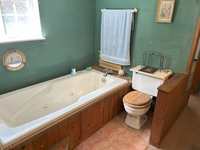 bathroom featuring toilet and a jetted tub