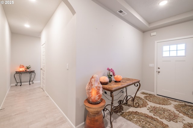 foyer featuring light wood-style flooring, recessed lighting, and baseboards