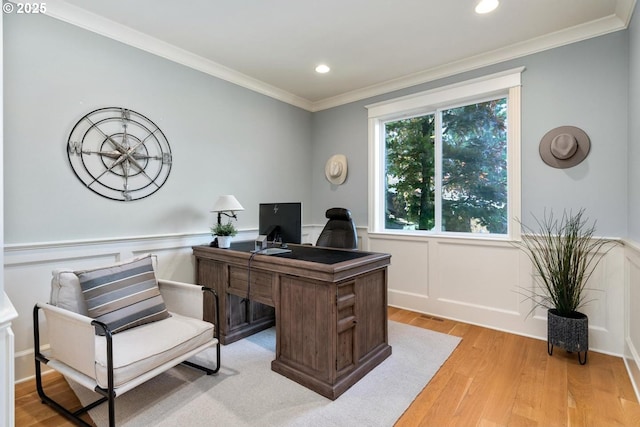 office space featuring light wood-type flooring, ornamental molding, recessed lighting, and a wainscoted wall