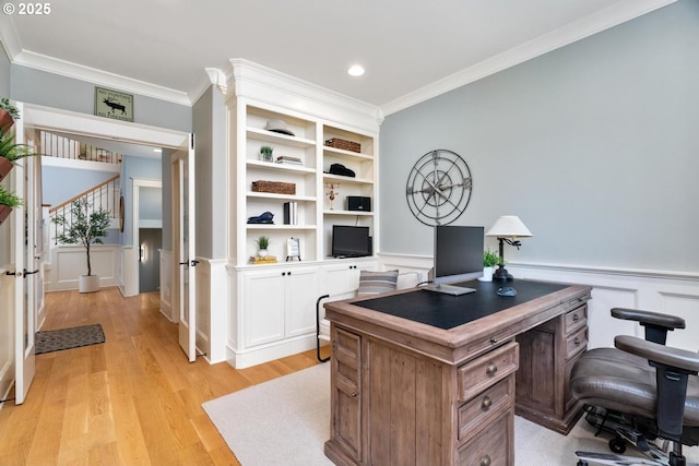 office with crown molding, light wood-type flooring, a wainscoted wall, recessed lighting, and a decorative wall
