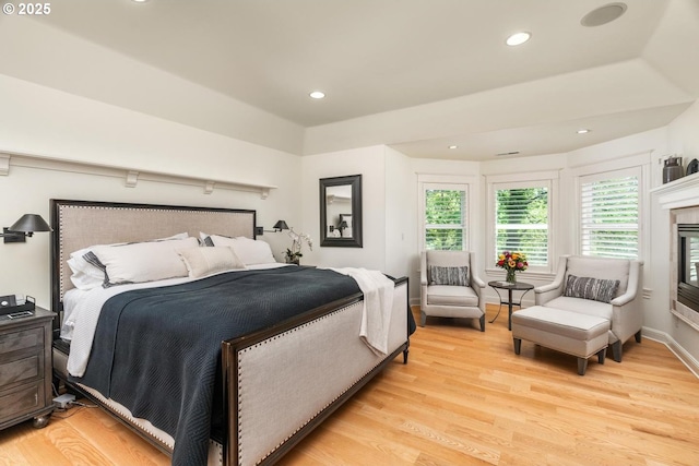 bedroom with light wood finished floors and recessed lighting