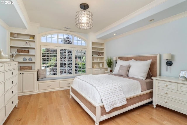 bedroom with light wood finished floors and crown molding