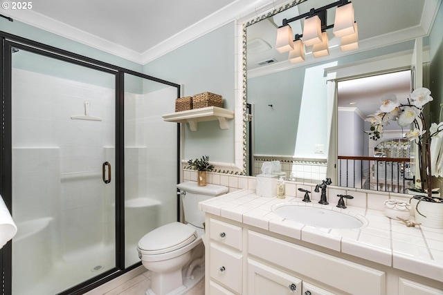 bathroom with crown molding, a stall shower, toilet, vanity, and tile patterned floors