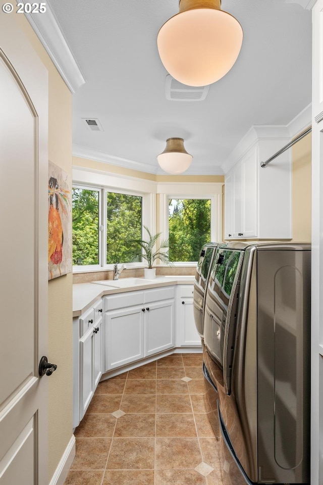 laundry room featuring cabinet space, washer and dryer, and healthy amount of natural light
