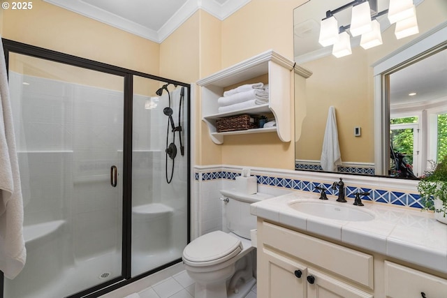 bathroom with ornamental molding, a shower stall, toilet, tile patterned flooring, and vanity