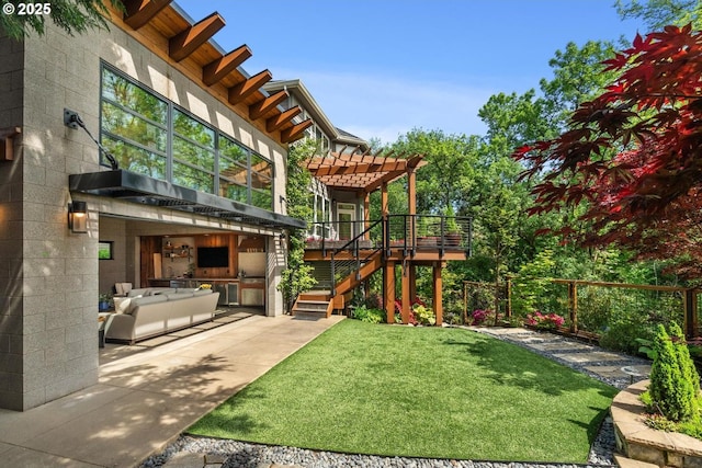 view of yard featuring a pergola, a patio, exterior kitchen, and stairway