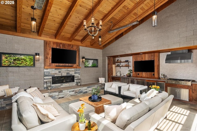 living area with wooden ceiling, beamed ceiling, a fireplace, high vaulted ceiling, and a chandelier