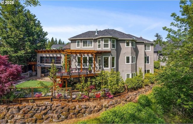 rear view of property with a pergola and a deck