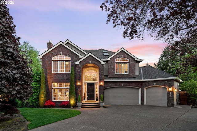 traditional-style house featuring driveway, brick siding, and a chimney