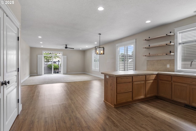 705 NW 25th Ave, Battle Ground, WA 98604 - kitchen featuring a sink, brown cabinetry, dark wood-style flooring, recessed lighting, and a textured ceiling