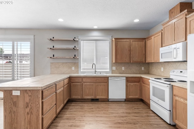 705 NW 25th Ave, Battle Ground, WA 98604 - kitchen with white appliances, a sink, a peninsula, open shelves, and recessed lighting