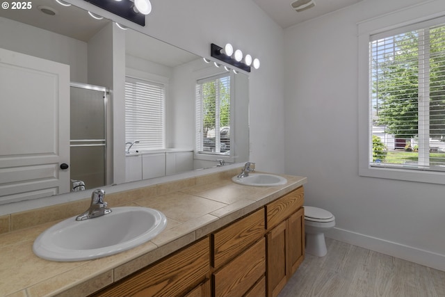705 NW 25th Ave, Battle Ground, WA 98604 - full bathroom featuring healthy amount of natural light, a stall shower, double vanity, and toilet