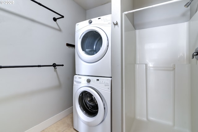 705 NW 25th Ave, Battle Ground, WA 98604 - laundry area with stacked washer / drying machine, light tile patterned flooring, and baseboards