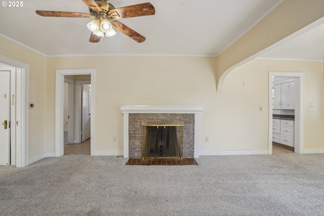 unfurnished living room with crown molding, carpet, ceiling fan, and baseboards