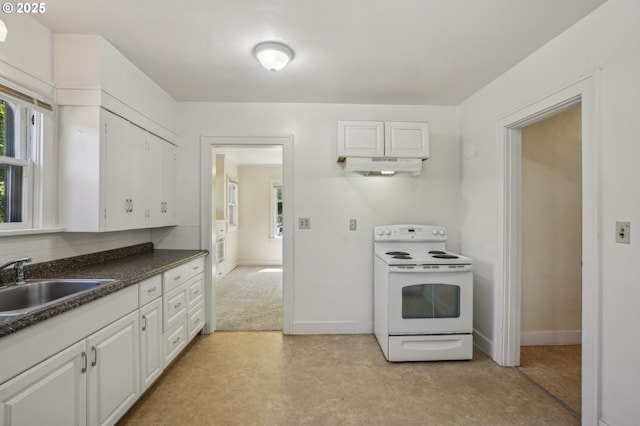 kitchen with electric range, dark countertops, a sink, white cabinets, and under cabinet range hood