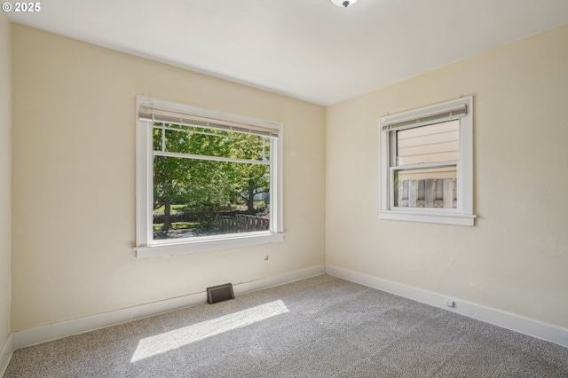 unfurnished room featuring baseboards and carpet