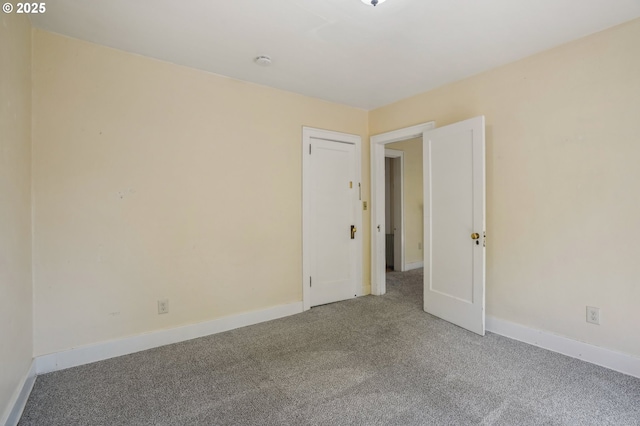 carpeted spare room with baseboards