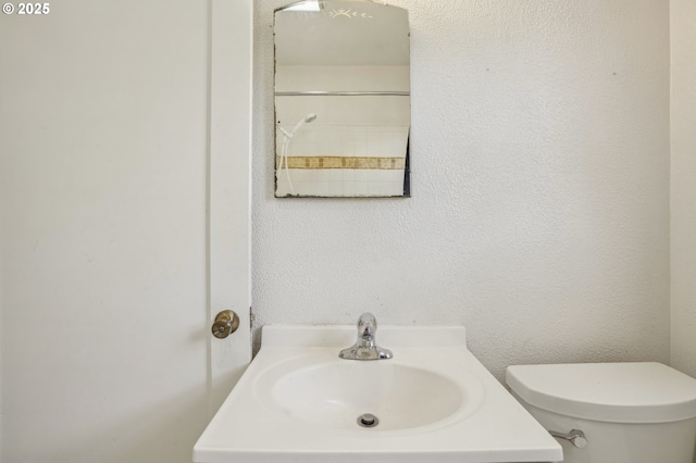 bathroom featuring toilet and a sink