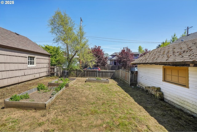 view of yard with a garden and fence