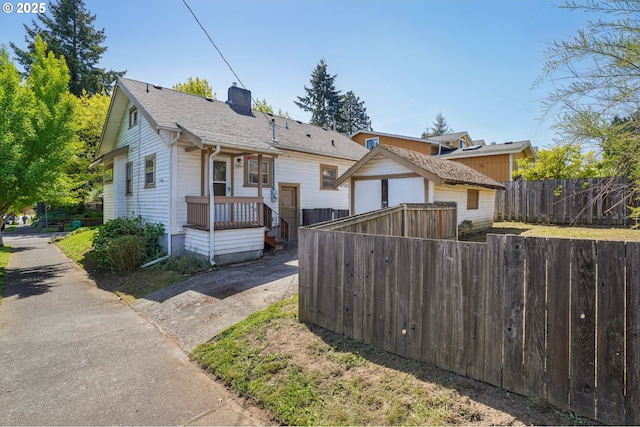 view of front of property with fence and a chimney