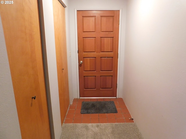 entryway with carpet floors