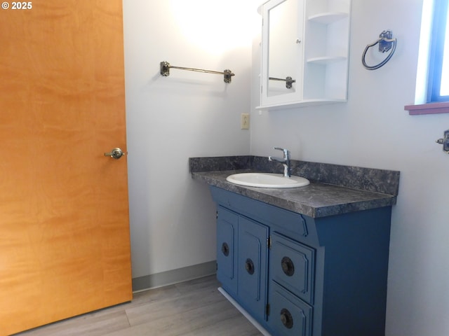 bathroom with vanity and hardwood / wood-style flooring