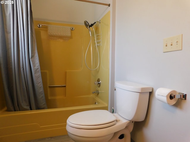 bathroom featuring wood-type flooring, shower / bathtub combination with curtain, and toilet