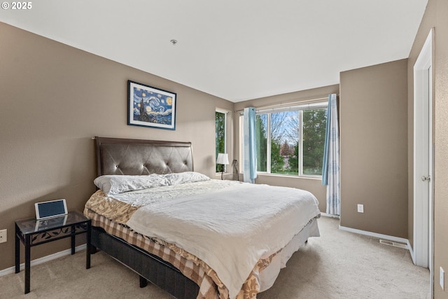 bedroom featuring light carpet and baseboards