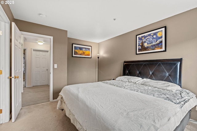 bedroom with baseboards and light carpet