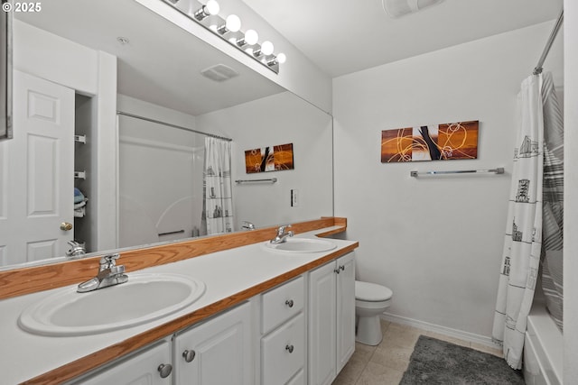 bathroom with a sink, visible vents, toilet, and tile patterned floors