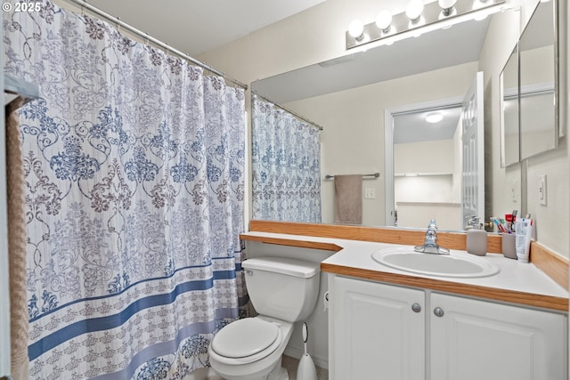 bathroom with vanity, curtained shower, and toilet