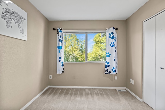 interior space with carpet flooring, visible vents, and baseboards