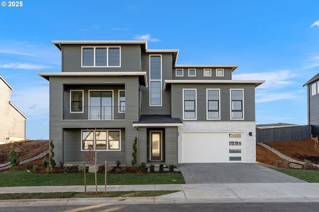 contemporary house with a garage and a balcony