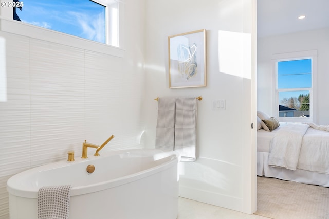 bathroom featuring a bathtub and plenty of natural light