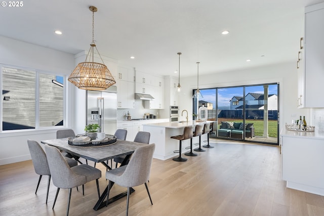 dining room with sink and light hardwood / wood-style floors