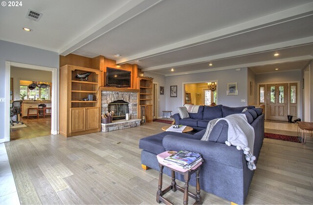 17130 Eastwood Ln, Brookings, OR 97415 - living room with a stone fireplace, beam ceiling, light wood-style flooring, a chandelier, and recessed lighting