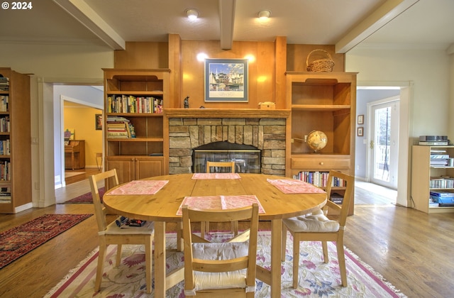 17130 Eastwood Ln, Brookings, OR 97415 - dining area featuring beam ceiling, wood finished floors, a fireplace, and crown molding